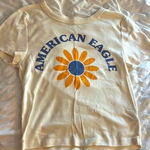 This baby tee is from American eagle. Cute little flower on the front with name.